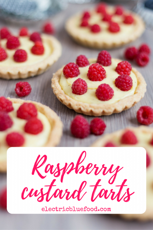Home-made custard tarts decorated with freshly picked raspberries