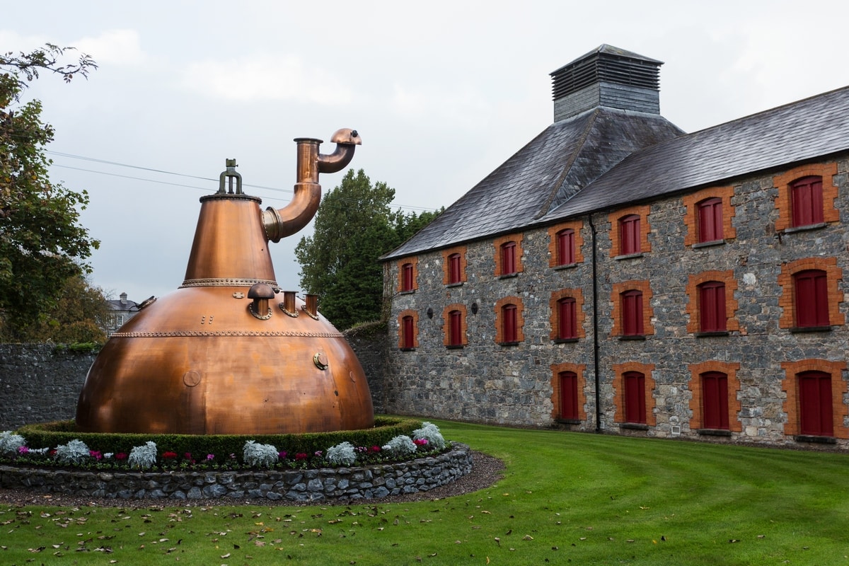 Jameson Experience distillery in Midleton, old pot still on display outside.