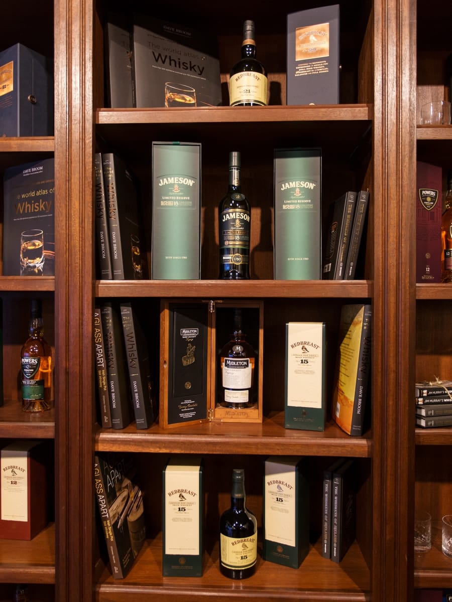 Irish whiskey bottles on a shelf.