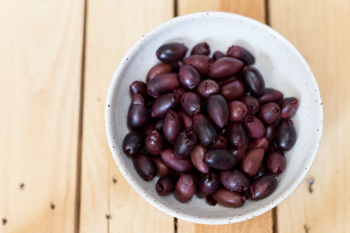Black olive paté, or black olive paste, spread on bread is one of those lovely alternatives to the classic garlic and tomato bruchetta topping.