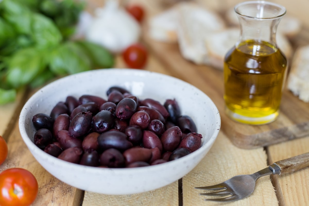 Black olive paté, or black olive paste, spread on bread is one of those lovely alternatives to the classic garlic and tomato bruchetta topping.