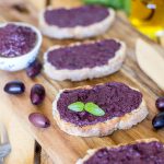 Black olive paté, or black olive paste, spread on bread is one of those lovely alternatives to the classic garlic and tomato bruchetta topping.