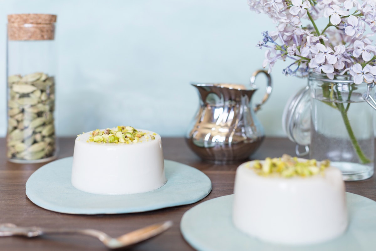 Two portions of panna cotta on light blue plates.