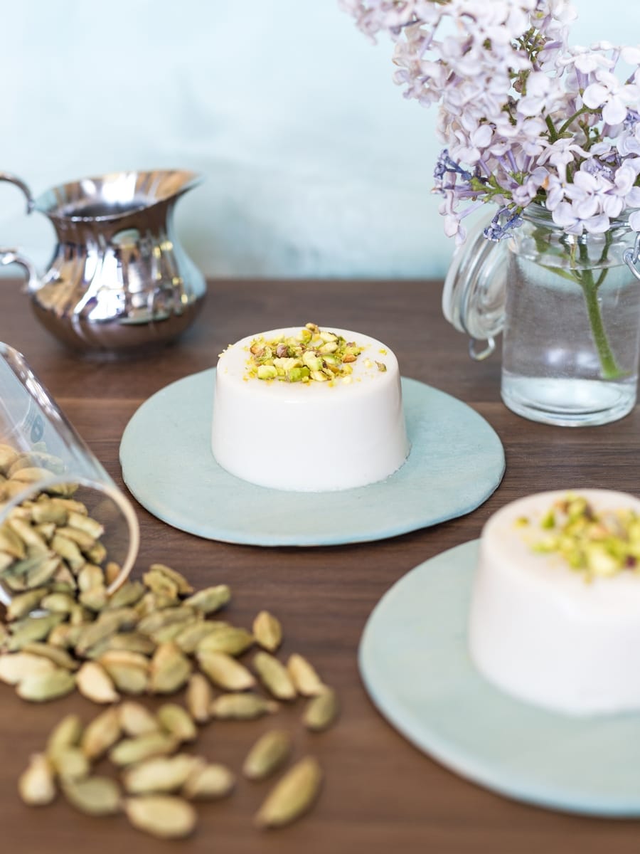 Coconut cardamom dessert with ground pistachio on top.