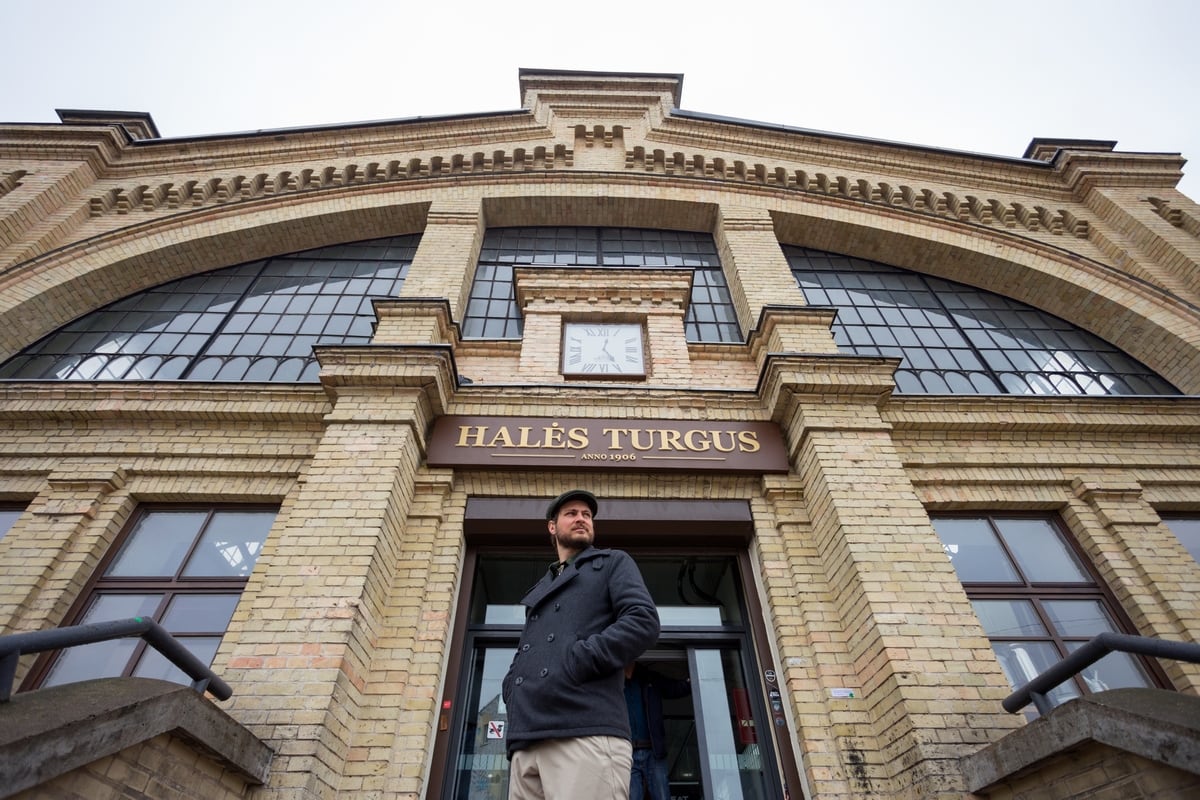 Man standing in front of Hales Turgus in Vilnius Lithuania