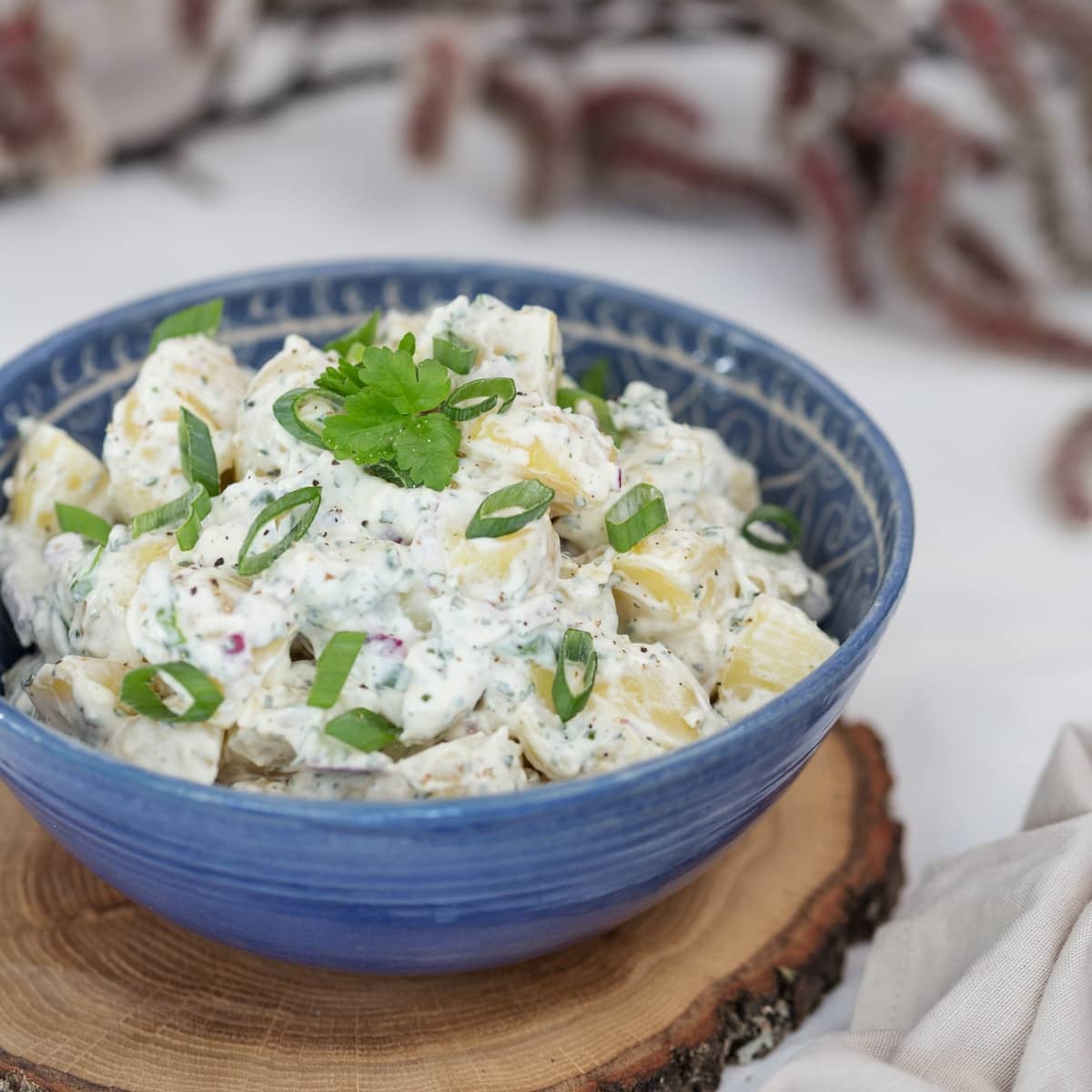 spring onion potato salad on a blue bowl
