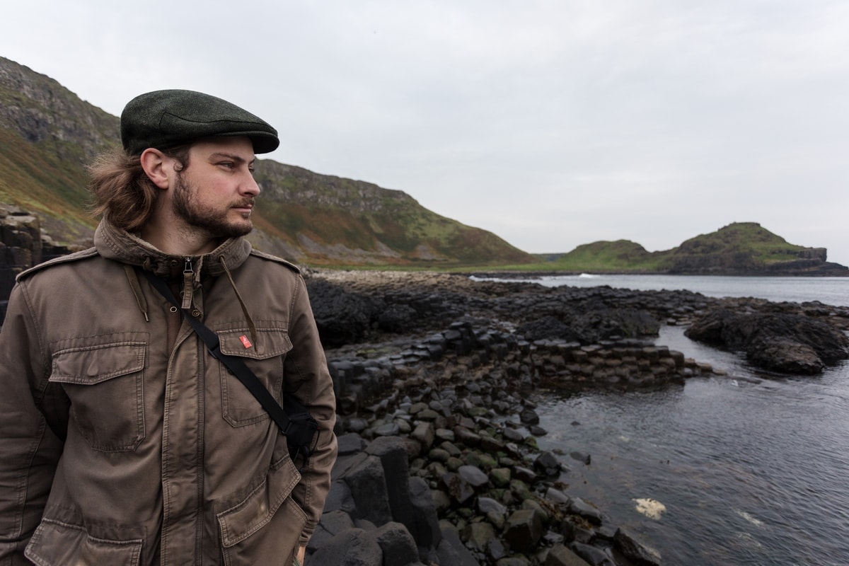 man with Irish hat at giant's causeway