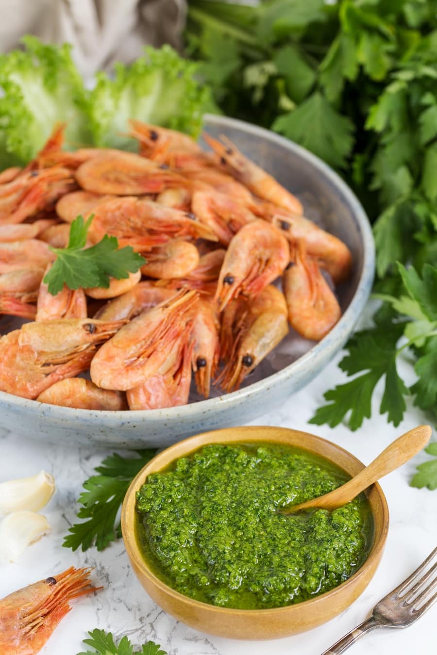 A small bowl of nordic pesto and a large bowl filled with smoked shrimp.