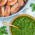 A small bowl with nordic pesto and a large bowl filled with smoked shrimp.