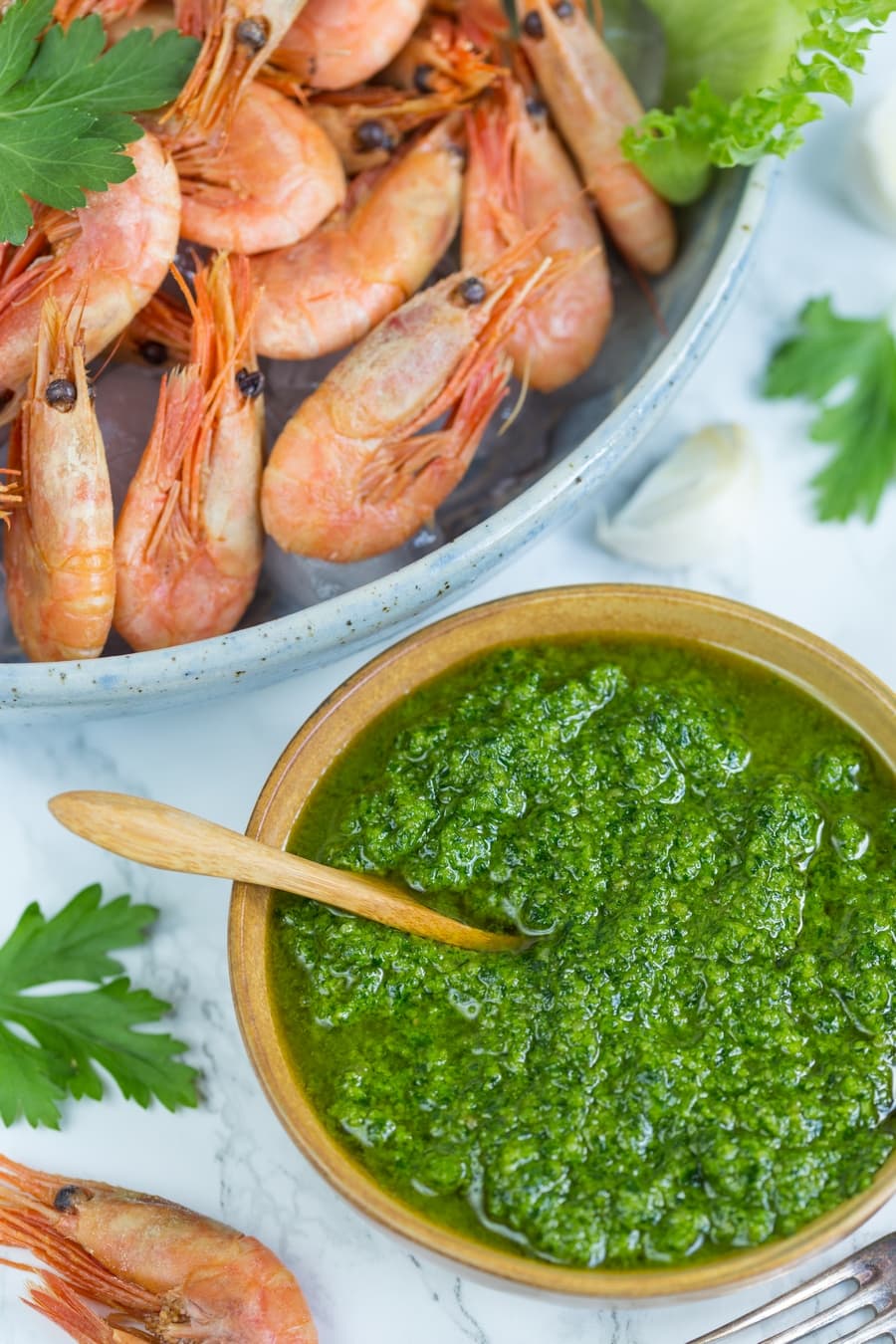 A small bowl with nordic pesto and a large bowl filled with smoked shrimp.