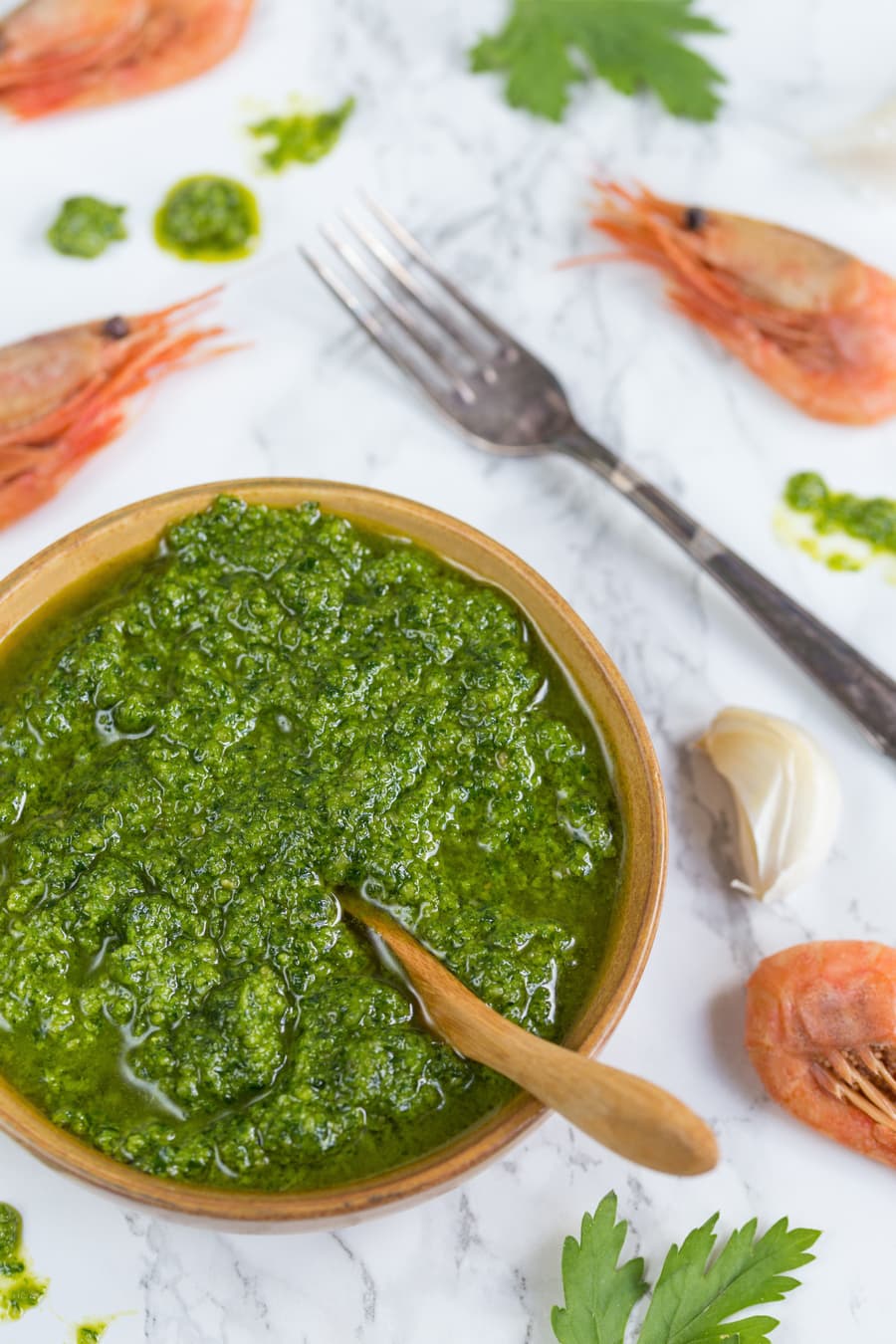 Bowl of pesto and shrimps on the table.