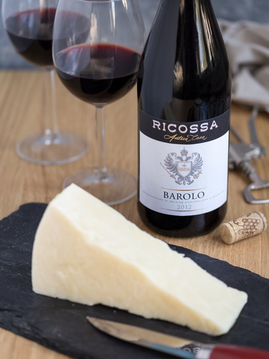 Bottle of Barolo red wine and chunk of Pecorino cheese.
