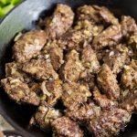 Cast iron pan with cooked chicken liver inside.