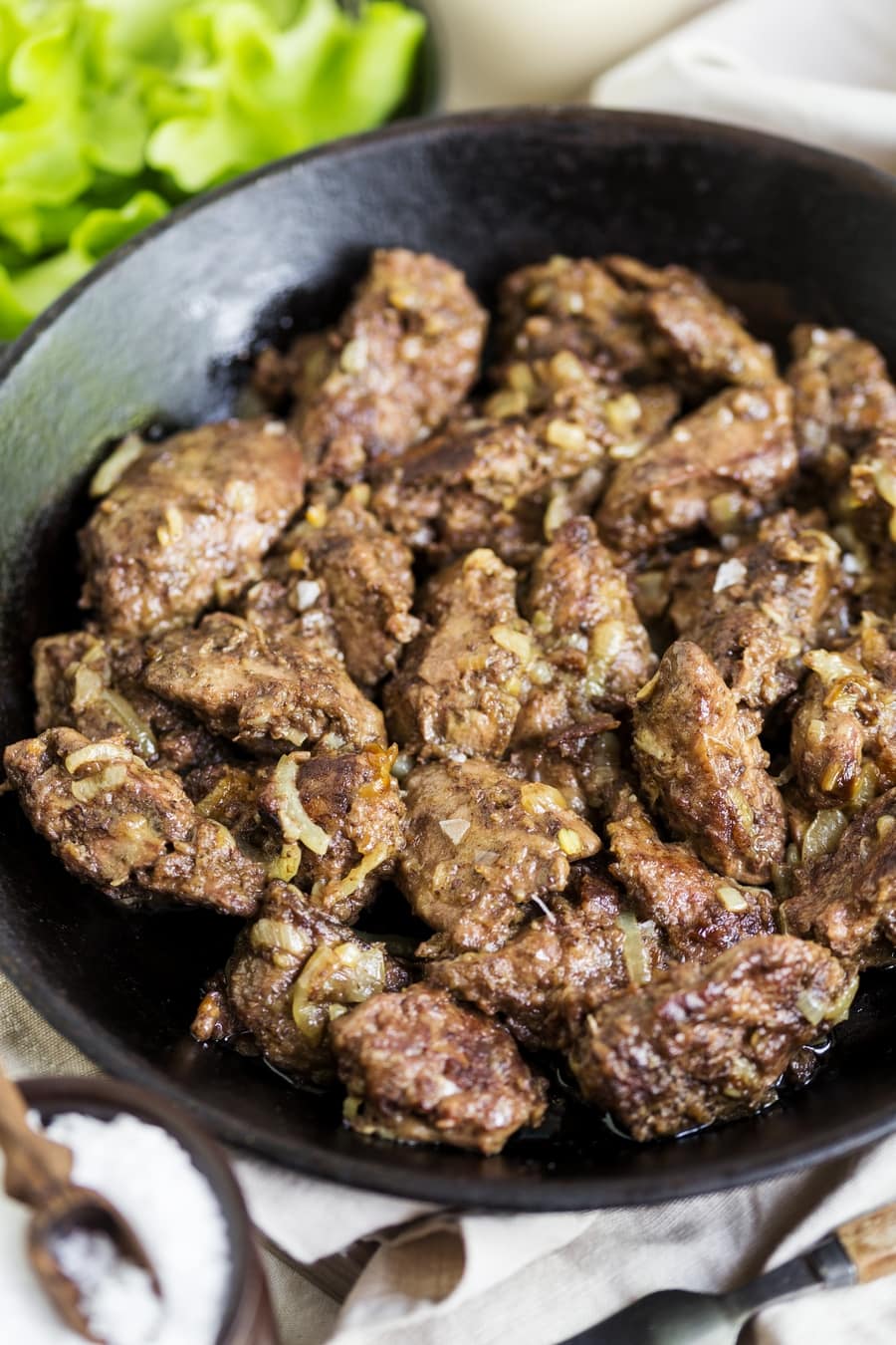 Cast iron pan with cooked chicken liver inside.