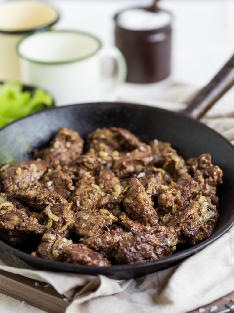 Chicken liver and onions in cast iron pan.