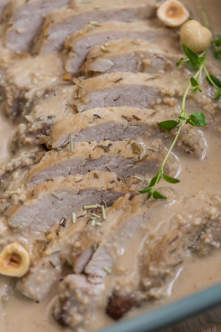 Baked pork loin in hazelnut sauce closeup.
