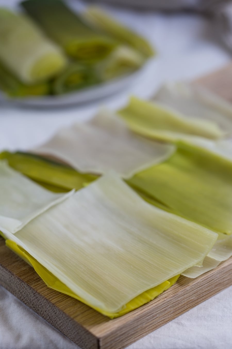 Boiled leeks rolled out to form the leek lasagna noodles.