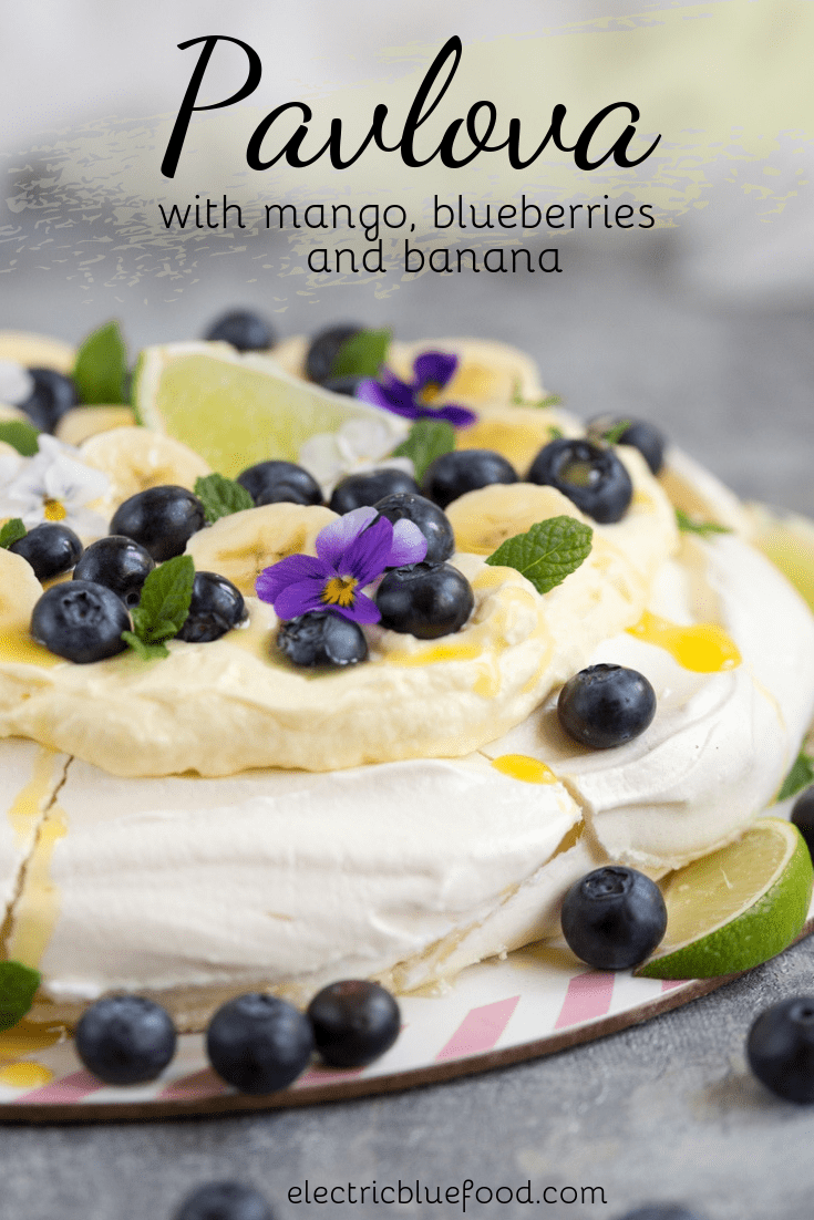 Pavlova with mango, blueberries and banana. A blue and yellow topping for this Australian cake.