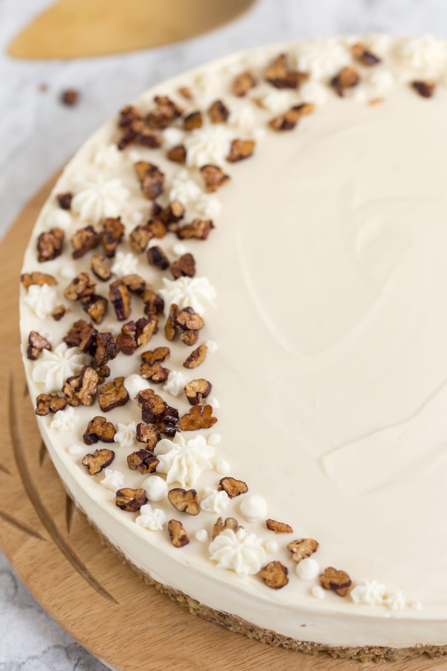 Roasted candied pecans and maple cream on cake.