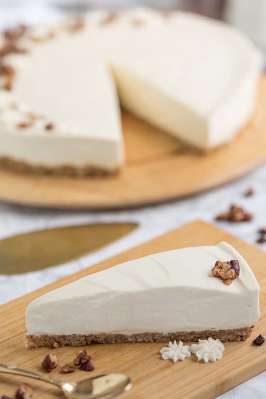 Maple cheesecake slice on wooden plate.
