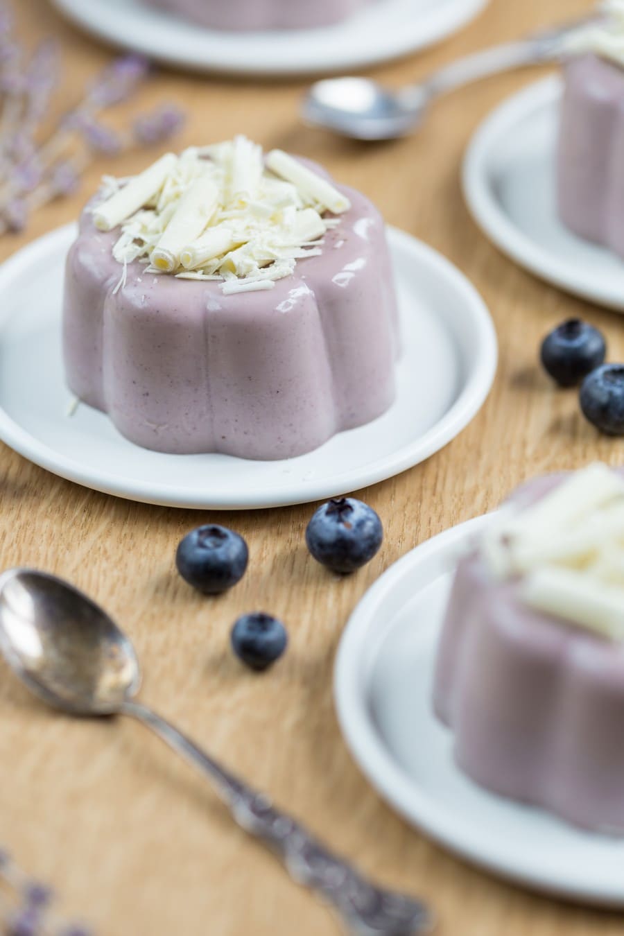 Blueberry lavender panna cotta served on white plate.