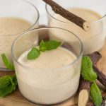 Closeup of liquorice panna cotta served in see-through glass.