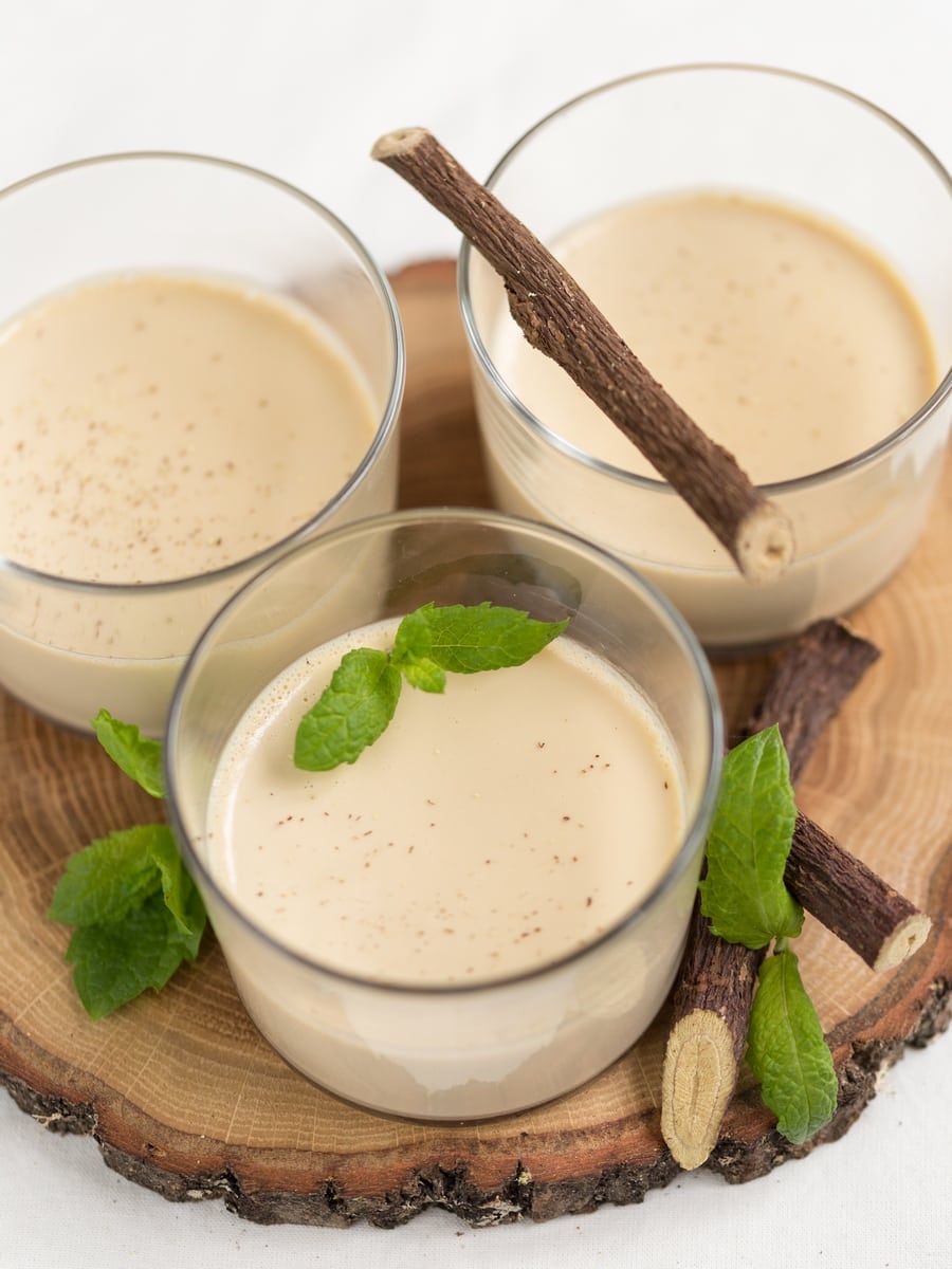 Liquorice panna cotta serving suggestion: with grated liquorice root and mint leaves.