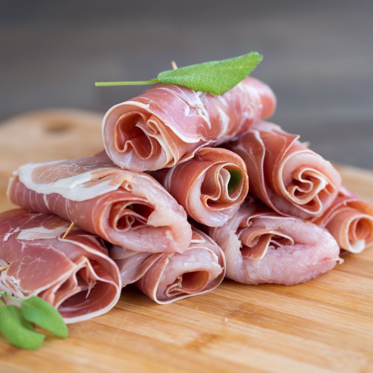 Rolled up raw chicken prosciutto involtini.