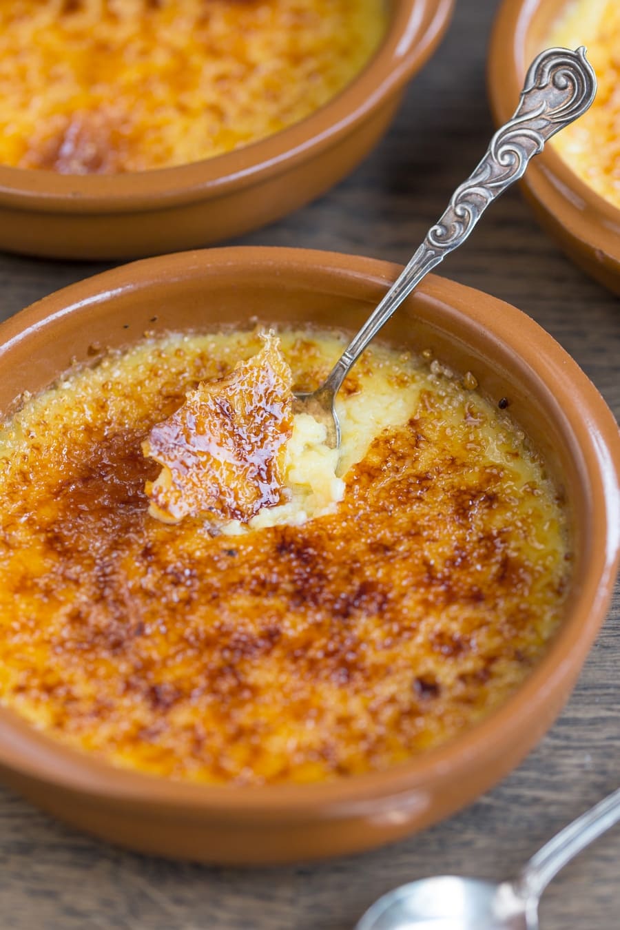 Lime crème brûlée cracked with a silver spoon.