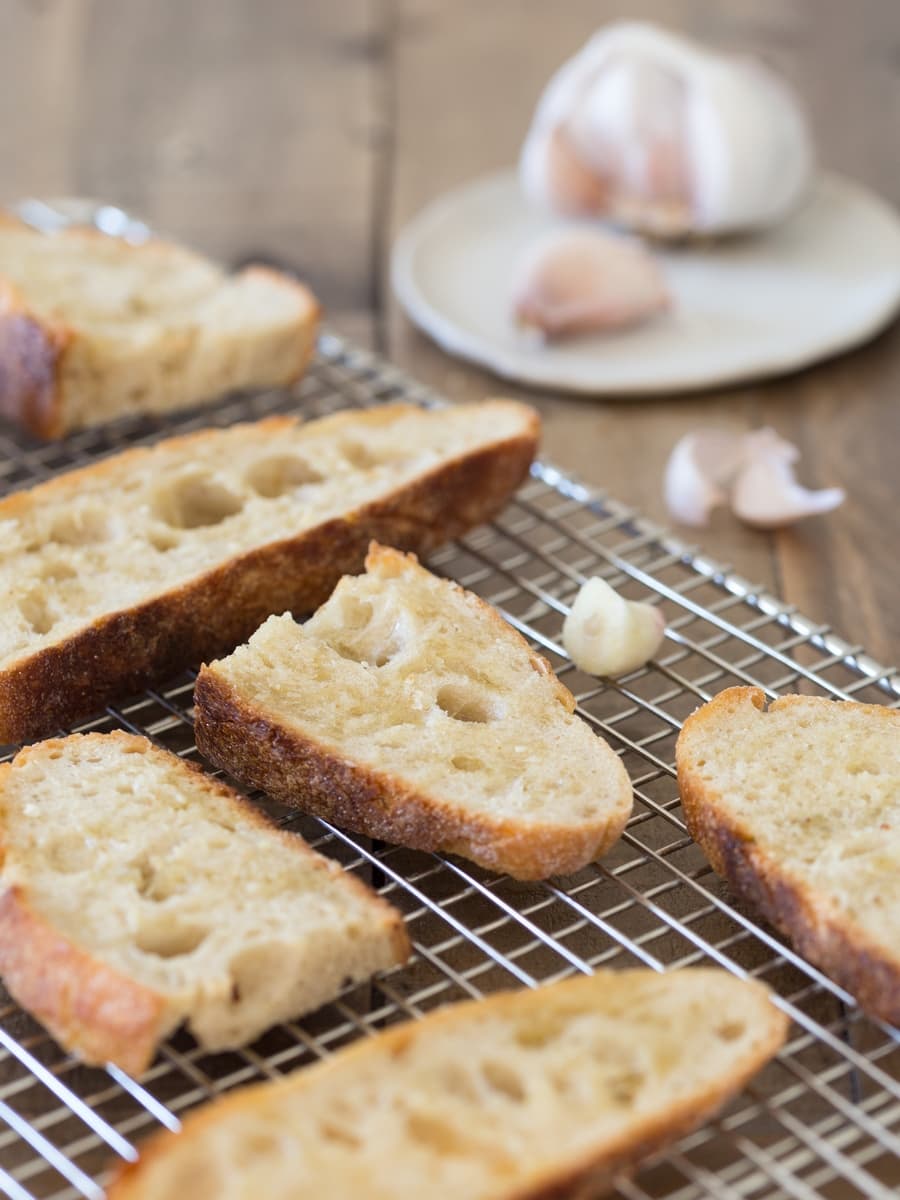 Toasted bread slices, rubbed with garlic clove.