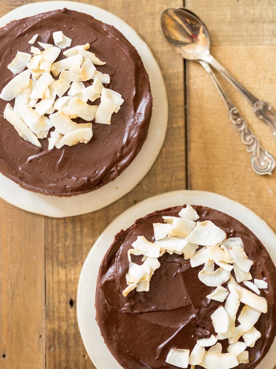 Flatlay image of raw food cakes with coconut flakes on top.