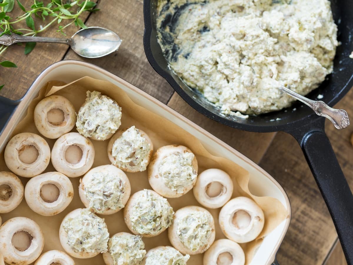Filling the mushroom caps with a hazelnut cream cheese mixture.