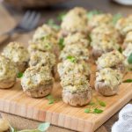 Baked vegetarian stuffed mushrooms decorated with fresh thyme.