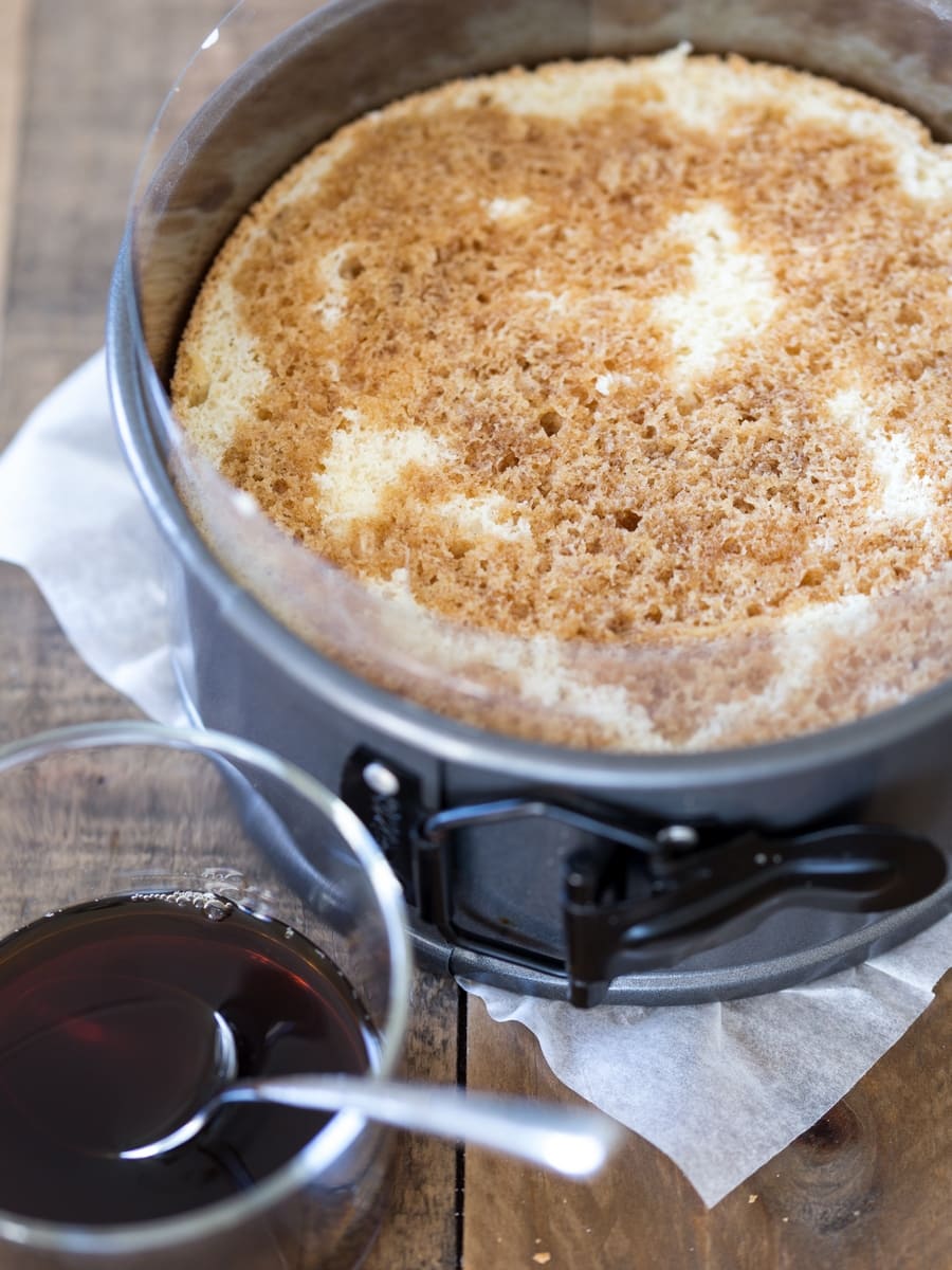 Sponge cake being soaked with coffee.