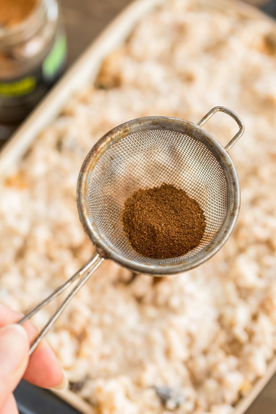 Ground cinnamon in a strainer.