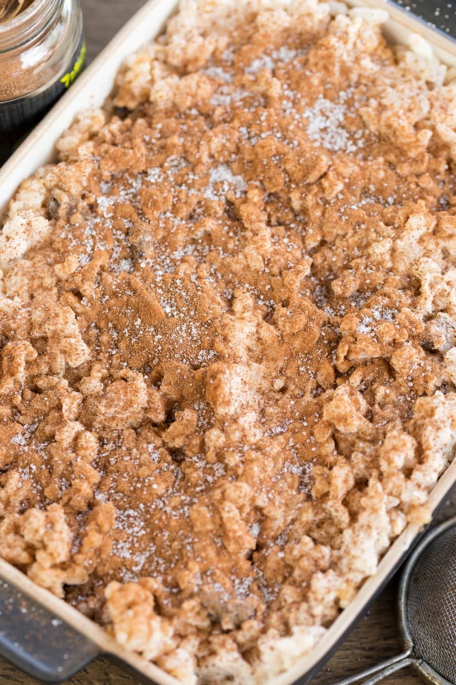 Baked rice with apples casserole sprinkled with ground cinnamon and sugar.