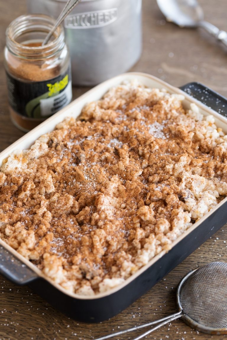 Baked rice with apples casserole sprinkled with ground cinnamon and sugar.