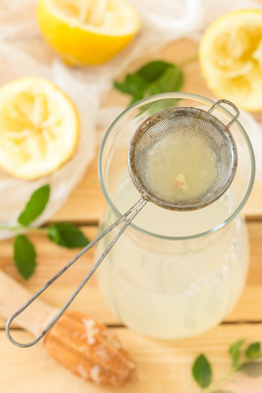 Making lemonade: lemon juice is strained to restain lemon pulp and seeds.