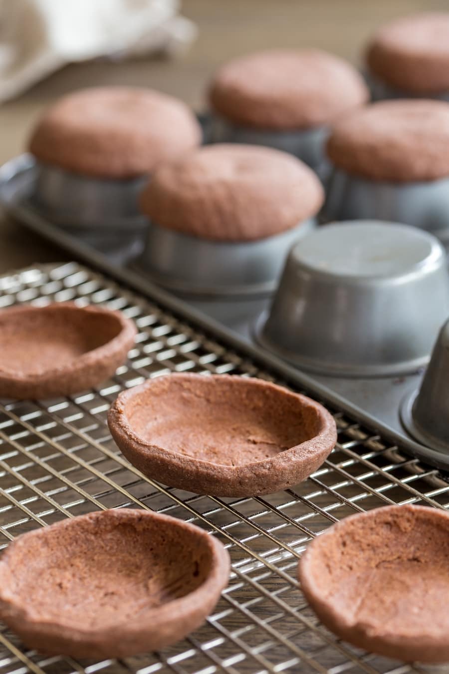 Shortcrust shells to be filled with mascarpone chocolate cream to make small chocolate mascarpone tarts.