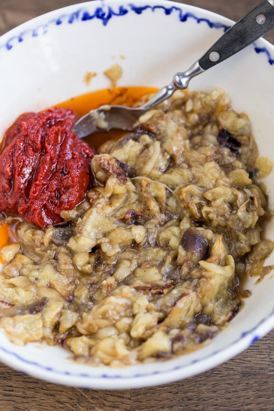 Baked eggplants mashed, tomato pste and chili oil added to the side.