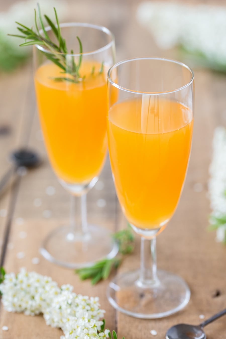 Mango cider bellini in champagne glasses.
