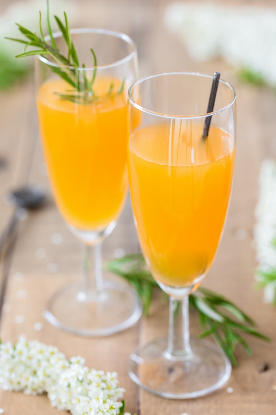Champagne glasses with mango cider cocktail.