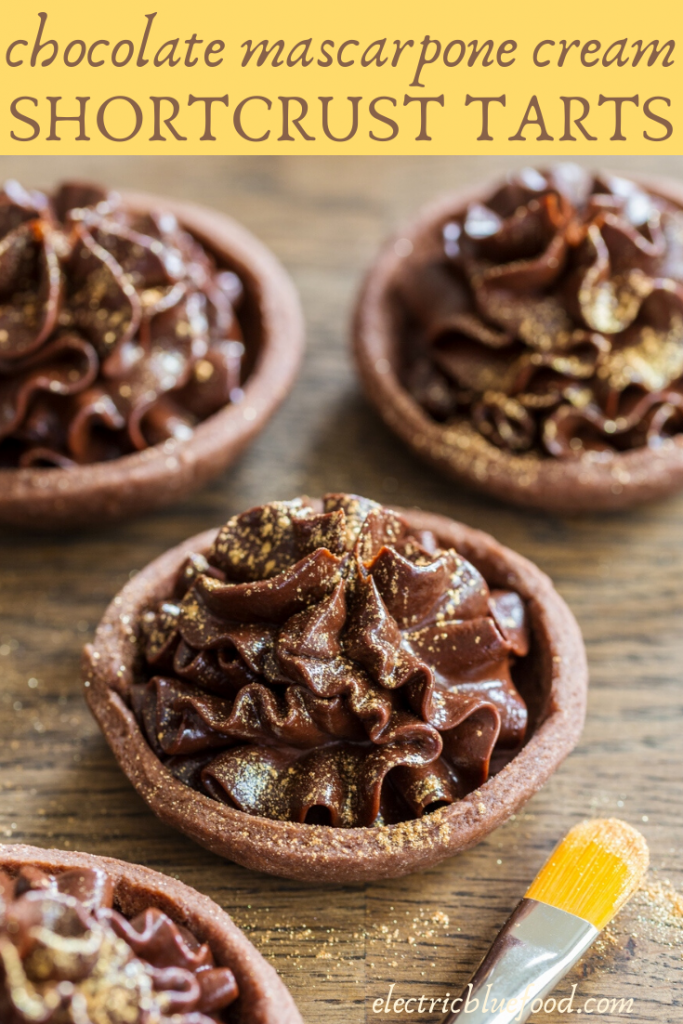 Chocolate mascarpone cream filled small shortcrust shells. Make these delicious chocolate mascarpone tarts and decorate them with edible glitter and flowers.