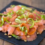 Smoked salmon carpaccio with shaved asparagus and grapefruit.