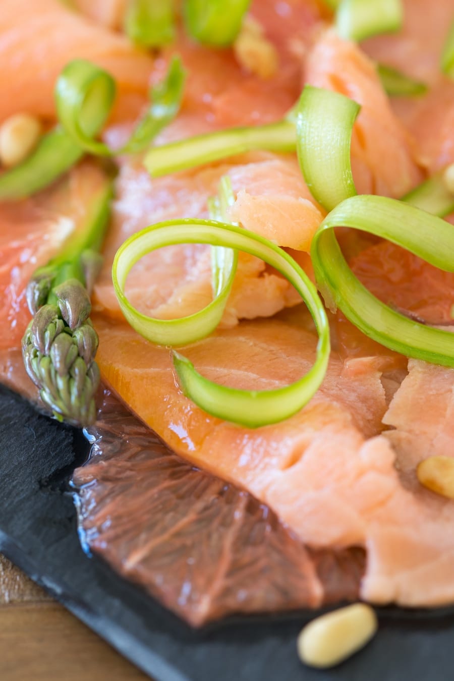 Detail of shaved asparagus on salmon carpaccio.
