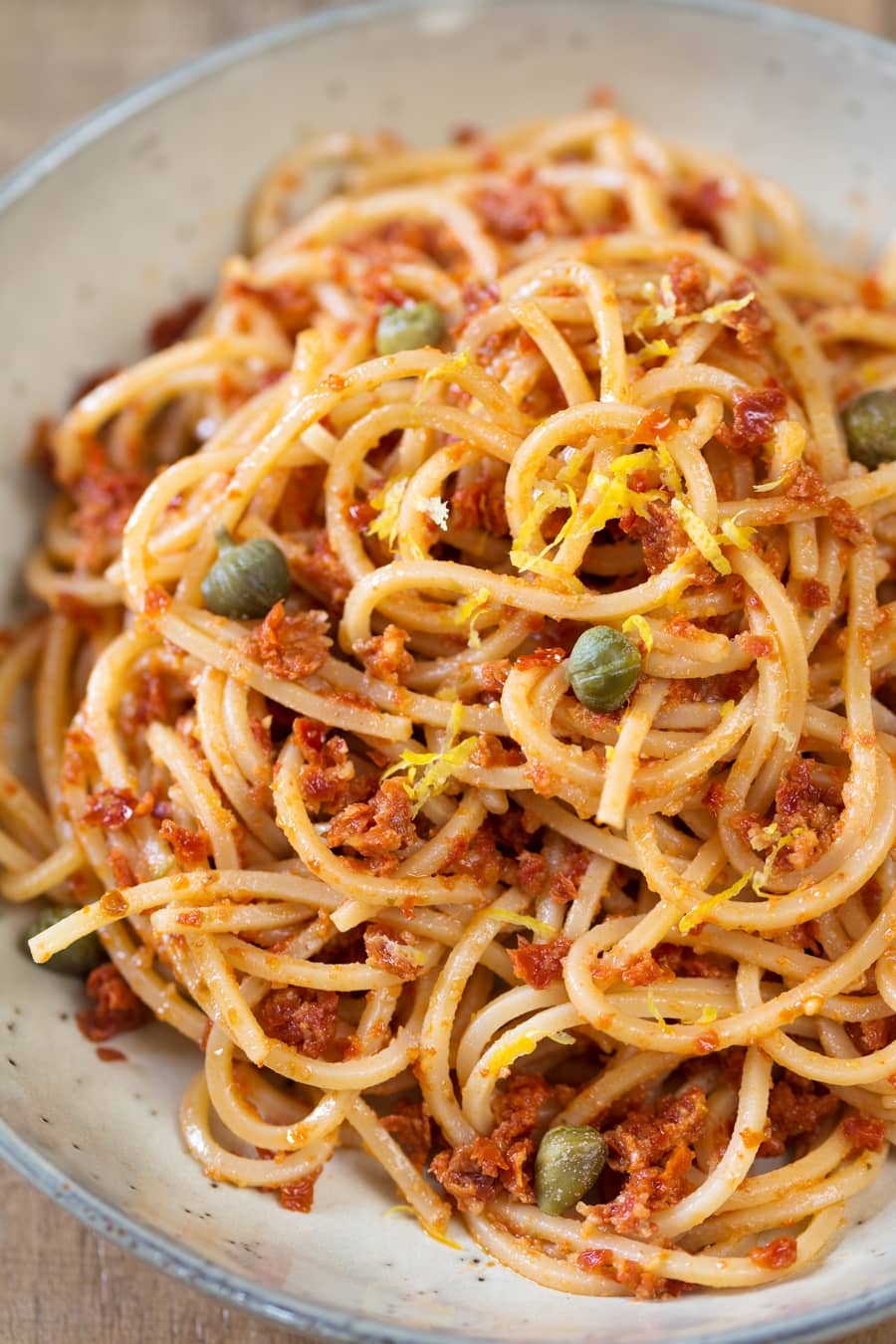 Spaghetti alla chitarra with red pesto, capers and lemon zest.