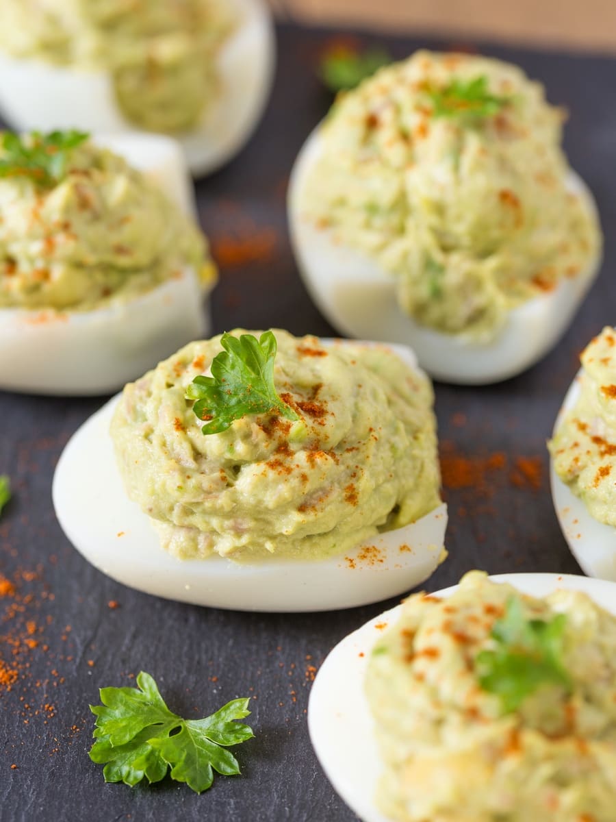 Tuna avocado eggs on black serving plate.