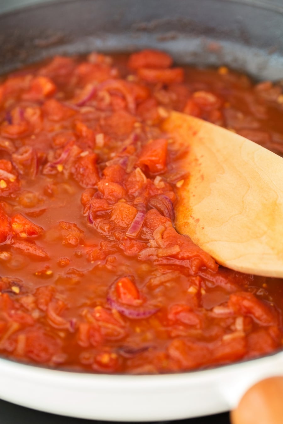 Balsamico onion pasta sauce with fresh tomatoes simmering in a skillet.