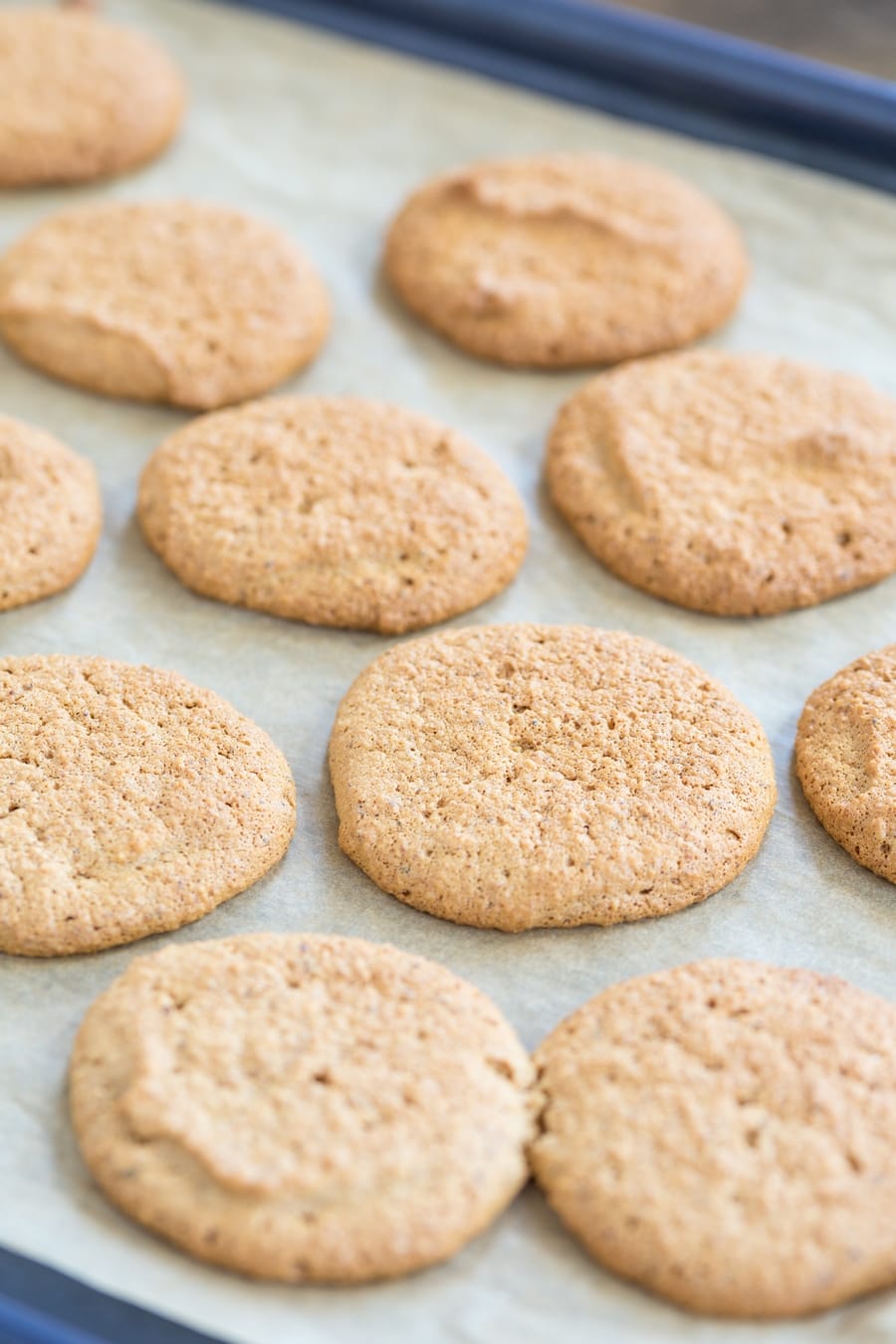 Honey hazelnut cookies on a sheet pan.