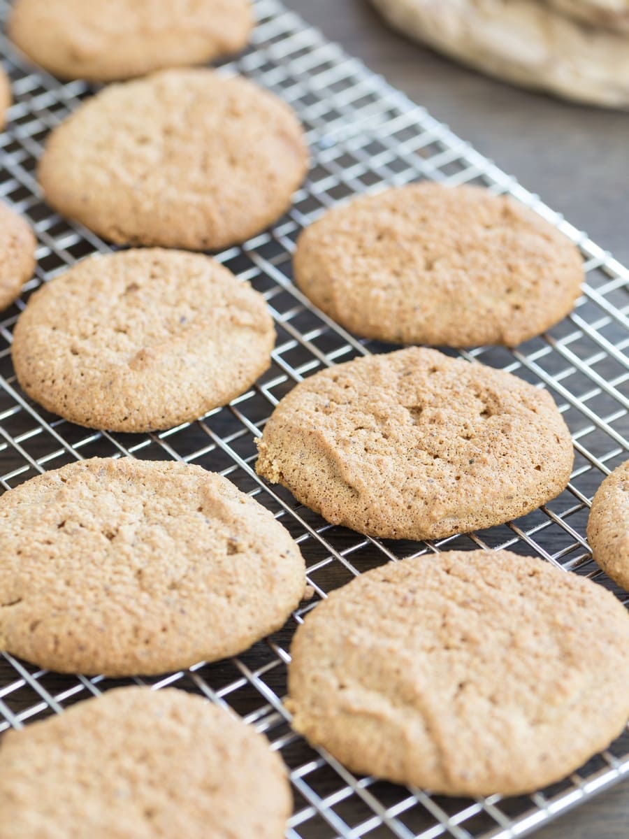 Baked honey hazelnut meringue cookies on a cooling rack.